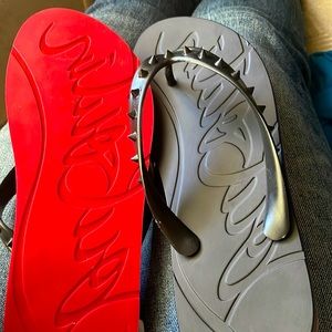 Black spiked Louboutin flip flops